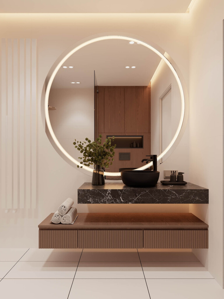 Projekt łazienki 7m2 z dużym podświetlanym okrągłym lustrem, czarną umywalką nablatową i wiszącą szafką z półką na ręczniki